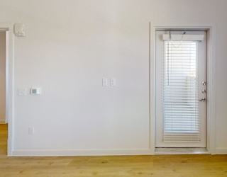 A room with a door and a window.