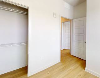 A white door is in a white room.