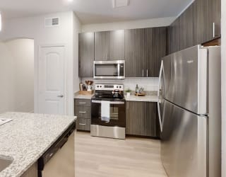 a kitchen with stainless steel appliances and granite countertops