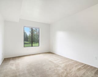 spacious bedroom with a window at Apple Ridge Apartments, Michigan, 49534