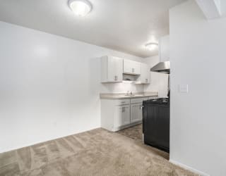 kitchen with white cabinets and dining area at Apple Ridge Apartments, Michigan, 49534