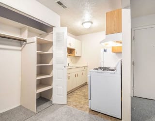 a renovated kitchen with white appliances and a closet at Apple Ridge Apartments, Walker