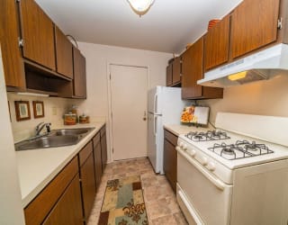 a kitchen with a stove and a refrigerator  at Apple Ridge Apartments, Walker