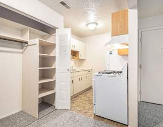 A kitchen and a closet with shelving at Apple Ridge Apartments, Walker, MI, 49534