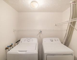 A laundry room with a full size washer and dryer at Brentwood Park Apartments in LaVista, NE