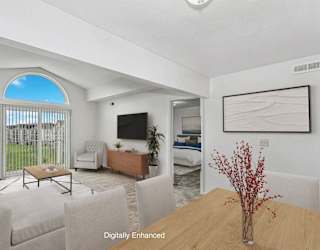 A living room with a cathedral ceiling at Brentwood Park Apartments in LaVista, NE
