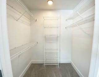 bedroom walk in closet with wardrobe organizers at The Crossings Apartments, Michigan, 49508