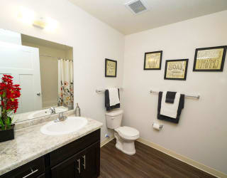 A bathroom with hard surface flooring at Copper Creek Apartment Homes, Maize, 67101
