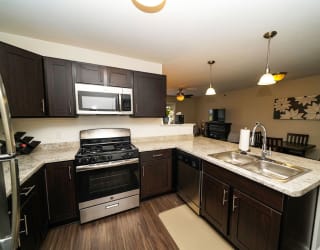 A kitchen with stainless steel appliances at Copper Creek Apartment Homes, Maize