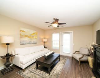 A living room with hard surface flooring and access to a patio at Copper Creek Apartment Homes, Kansas, 67101