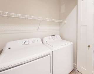 a laundry room with washer and a dryer at Copper Creek Apartment Homes in KS 67101
