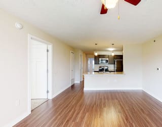Two bedroom living room and kitchen with hard surface floors at Copper Creek Apartment Homes in Maize, KS 67101
