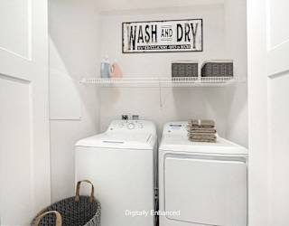 A laundry area with a full size washer and dryer at Copper Creek Apartment Homes, Kansas, 67101