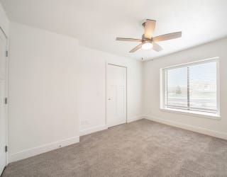 Bedroom with ceiling fan at The Crossings Apartments, Grand Rapids, 49508