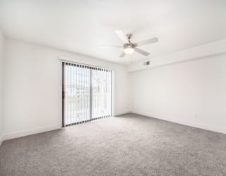 Large living room with ceiling fan at The Crossings Apartments, Grand Rapids, MI, 49508
