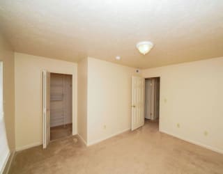A bedroom with a walk in closet at Dupont Lakes Apartments, Indiana, 46825