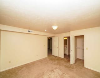 A bedroom with an ensuite and a walk in closet at Dupont Lakes Apartments, Fort Wayne, Indiana