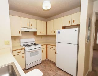 A kitchen with white appliances at Dupont Lakes Apartments, Fort Wayne, IN, 46825