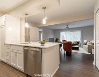 a kitchen and living room in a 555 waverly unit at Hillside Apartments, Michigan