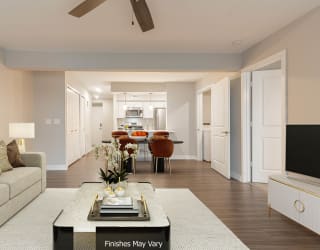 a living room with a couch and a coffee table in front of a tv at Hillside Apartments, Wixom, 48393