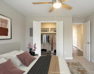 a bedroom with a large bed and a ceiling fan at Hillside Apartments, Michigan, 48393