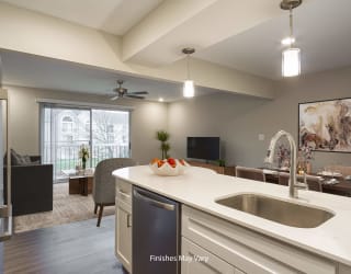 a kitchen and living room with a large window and a ceiling fan at Hillside Apartments, Michigan
