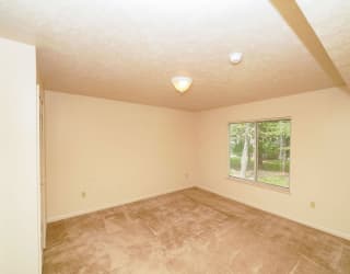a empty living room with a large window