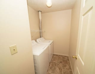 a small bathroom with a washer and dryer in it