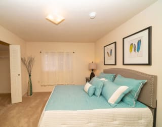 a bedroom with a bed and a closet  at Hurwich Farms Apartments, South Bend, Indiana