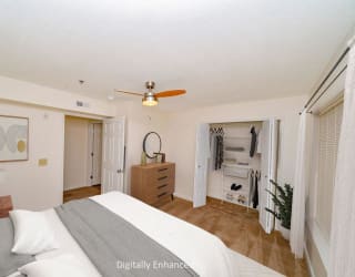 a bedroom with a bed and a ceiling fan
