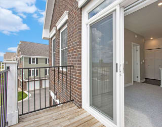 a sliding glass door in a home with a deck at Meadowbrooke Apartment Homes, Grand Rapids, MI, 49512