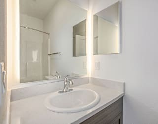 a bathroom with a sink and a mirror at Meadowbrooke Apartment Homes, Grand Rapids, Michigan
