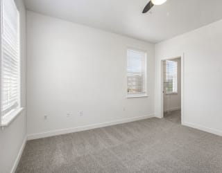 a living room with carpet and a door to a bathroom at Meadowbrooke Apartment Homes, Grand Rapids, Michigan