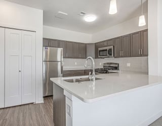 a kitchen with a sink and a refrigerator at Meadowbrooke Apartment Homes, Grand Rapids, 49512