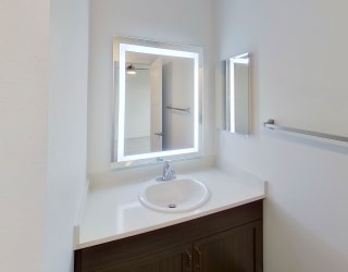 a bathroom with a sink and a mirror at Meadowbrooke Apartment Homes, Grand Rapids, Michigan