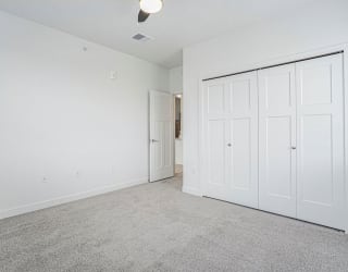 an empty bedroom with white walls and white doors at Meadowbrooke Apartment Homes, Grand Rapids, Michigan