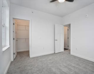 a bedroom with a closet and a ceiling fan at Meadowbrooke Apartment Homes, Grand Rapids, MI