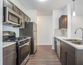 a kitchen with stainless steel appliances and a sink at Meadowbrooke Apartment Homes, Grand Rapids, MI, 49512