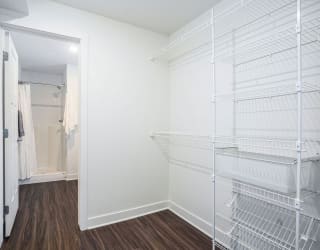 a closet in a bedroom with a mirrored closet door at Meadowbrooke Apartment Homes, Grand Rapids