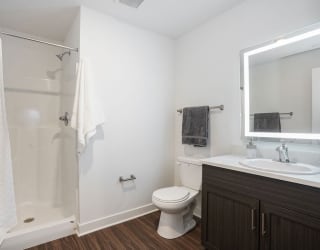 a bathroom with a shower toilet and sink at Meadowbrooke Apartment Homes, Michigan