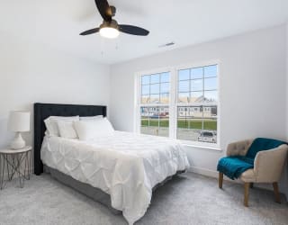 a bedroom with a bed and a ceiling fan at Meadowbrooke Apartment Homes, Michigan, 49512