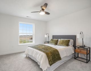 a bedroom with a bed and a ceiling fan at Meadowbrooke Apartment Homes, Grand Rapids