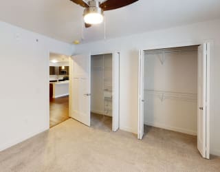 a bedroom with a closet and a ceiling fan at Meadowbrooke Apartment Homes, Grand Rapids, Michigan