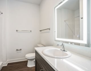 a bathroom with a sink and a toilet and a mirror at Meadowbrooke Apartment Homes, Grand Rapids, MI, 49512