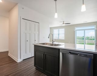 an empty kitchen with a sink and a window at Meadowbrooke Apartment Homes, Michigan, 49512