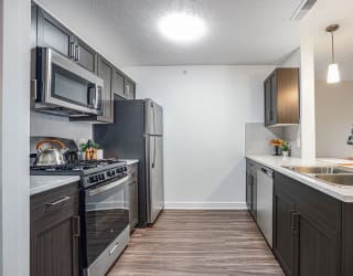 a kitchen with stainless steel appliances and a sink at Meadowbrooke Apartment Homes, Grand Rapids