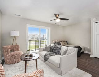 a living room with a couch and a bed at Meadowbrooke Apartment Homes, Grand Rapids, Michigan
