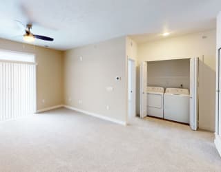 an empty living room with a closet and a laundry room at Meadowbrooke Apartment Homes, Grand Rapids, MI, 49512