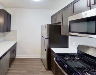 a kitchen with stainless steel appliances and white counter tops at Meadowbrooke Apartment Homes, Grand Rapids