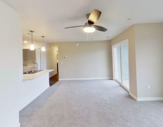 an empty living room with a ceiling fan at Meadowbrooke Apartment Homes, Grand Rapids, Michigan